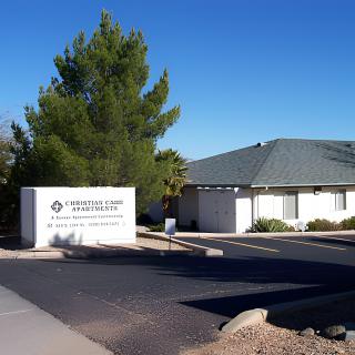 Exterior view of a clinic with signage and surrounding trees on a clear day.