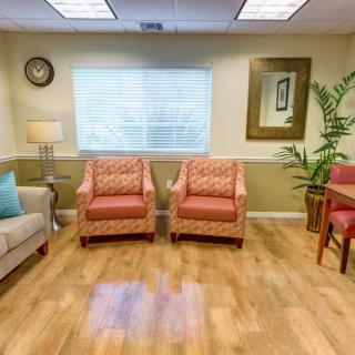 A cozy waiting room with comfortable seating and warm decor.
