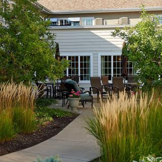 A tranquil garden patio with outdoor seating and landscaped surroundings.