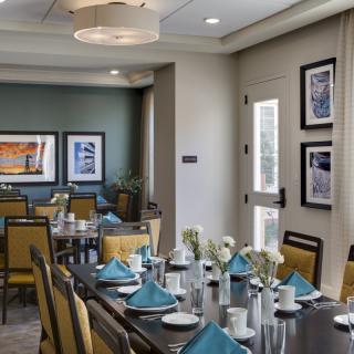 A modern dining room with elegant table settings and contemporary decor.