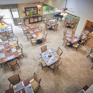 An overhead view of a spacious restaurant dining area with neatly arranged tables and chairs.