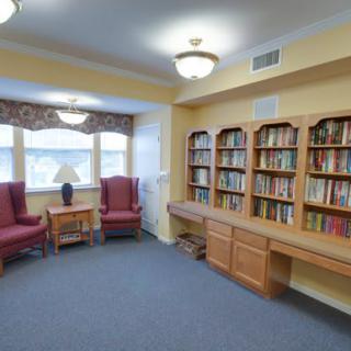 A cozy library corner with bookshelves and comfortable seating.