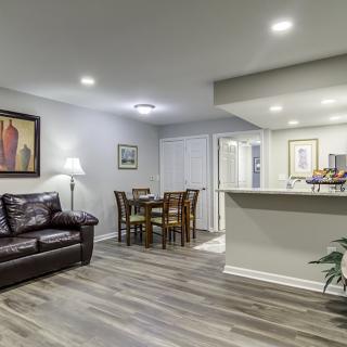 A modern living room with a cozy seating area, dining table, and contemporary decor.