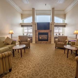 A cozy living room with a fireplace and comfortable seating.
