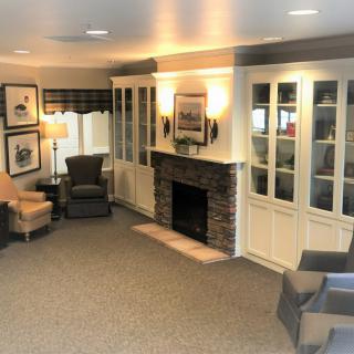 A cozy living room with a fireplace and comfortable seating.
