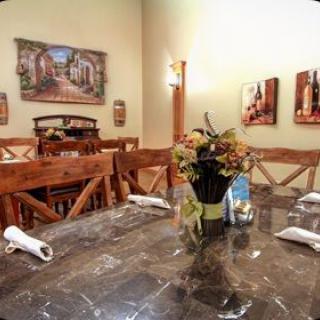 A cozy dining room with a decorated table and wall art.