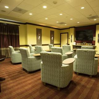 A comfortable lounge area with arranged seating and warm lighting.