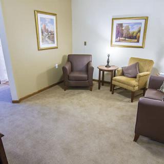 A cozy living room with comfortable seating and decorative artwork.