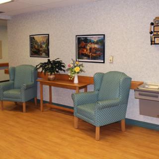 A well-decorated waiting area with comfortable seating and art on the walls.