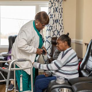 A caregiver providing assistance to a patient in a comfortable setting.