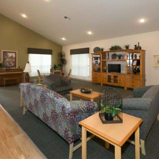 A cozy living room with comfortable seating and an entertainment center.