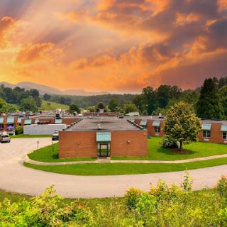 A serene view of a residential area under a vibrant sunset.