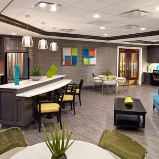 A modern living space featuring an open plan with a kitchen and seating area, adorned with contemporary furniture and decor.