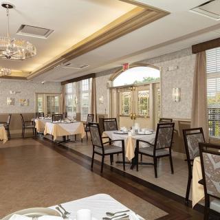 An elegant restaurant dining area with neatly arranged tables and chairs.