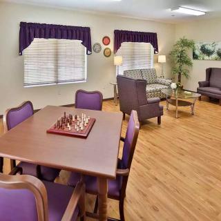 A cozy living room with a chess board on the table and comfortable seating.