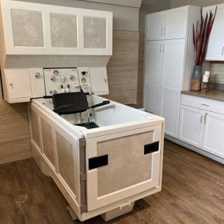 A modern kitchen setting featuring a unique sink with cabinetry above.