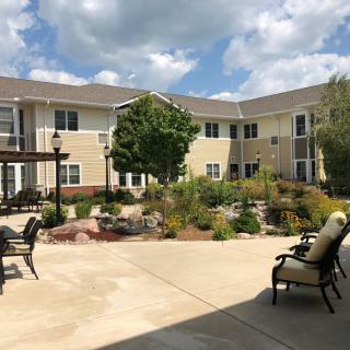 A well-maintained courtyard with outdoor seating at an apartment complex.