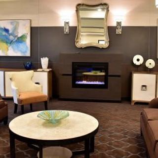 A modern living room with a cozy fireplace and stylish decor.