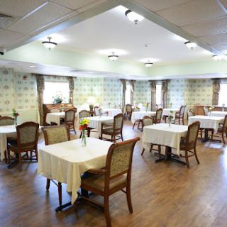 A spacious and elegantly designed dining room with neatly arranged tables and chairs.