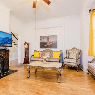 A cozy living room featuring elegant furniture, a TV, and warm decor.