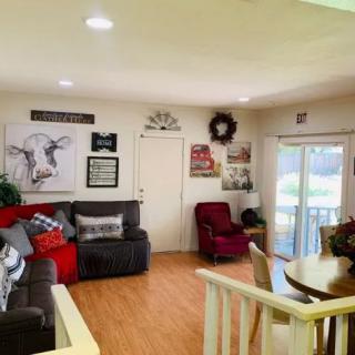 Cozy living room with comfortable seating and decorative wall art.