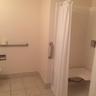 An accessible bathroom with a walk-in shower and safety features.