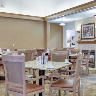 An empty dining area with neatly arranged tables and chairs.