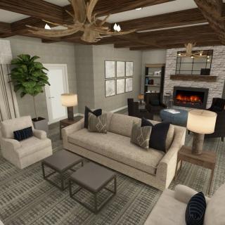 A modern living room with neutral colors, featuring a cozy sofa, armchairs, and a fireplace under wooden ceiling beams.