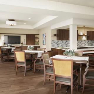 A modern dining area with neatly arranged tables and chairs, complemented by stylish lighting and wood flooring.