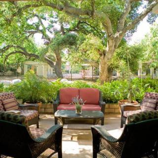 A cozy outdoor seating area in a lush garden setting.