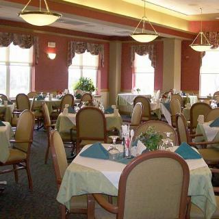 A well-lit restaurant dining room with neatly arranged tables and chairs.