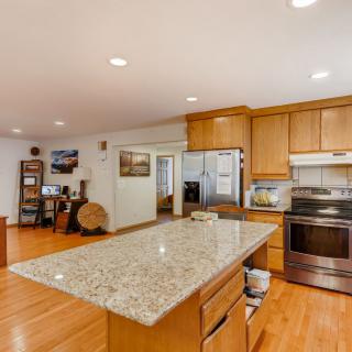 A modern kitchen with a spacious open layout and wooden cabinetry.