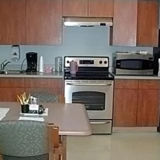A modern kitchen with appliances, including a stove and microwave.