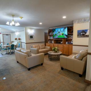 A modern living room with comfortable seating and a large television.