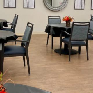 A modern dining area with elegantly set tables and stylish chairs.