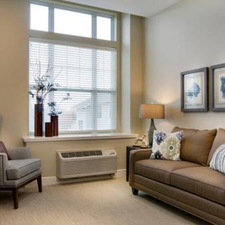 A cozy living room with neutral tones and stylish decor.
