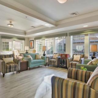 A well-lit modern living room with comfortable seating and stylish decor.