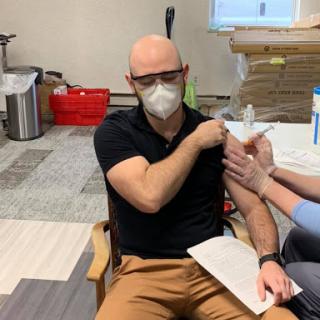 A patient receiving a COVID-19 vaccination at a healthcare facility.