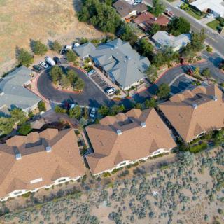 Aerial view of a residential neighborhood with multiple buildings and landscaped surroundings.