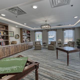 A modern library room with comfortable seating and ample natural light.