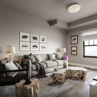 A modern and cozy living room featuring a comfortable sofa, decorative artwork, and stylish coffee tables.