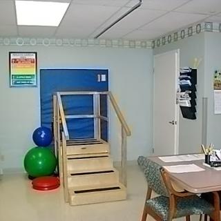 A therapy room equipped with stairs and exercise balls for rehabilitation activities.