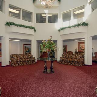 Spacious hotel lobby with elegant decor and seating arrangements.