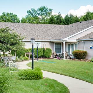 A suburban home with a well-maintained lawn and garden path.