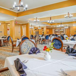 An elegant restaurant dining room with beautifully set tables and classic decor.