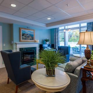 A cozy and well-decorated living room featuring comfortable seating, a fireplace, and tasteful decor.