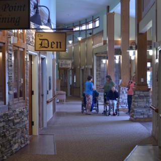 A spacious and modern shopping hallway featuring a variety of shops, including one labeled 'Den'.