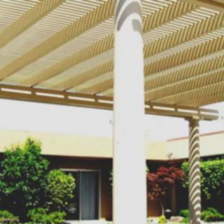Outdoor patio area with a pergola and column structure.