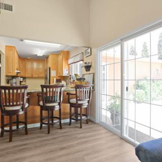 A cozy kitchen with a breakfast bar and sliding glass doors letting in natural light.