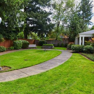 A well-maintained garden with a curving pathway and gazebo.